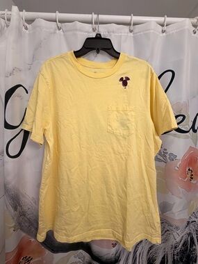 Disney Men's Pale Yellow Short Sleeve Pocket Tee with Small Burgundy Graphic